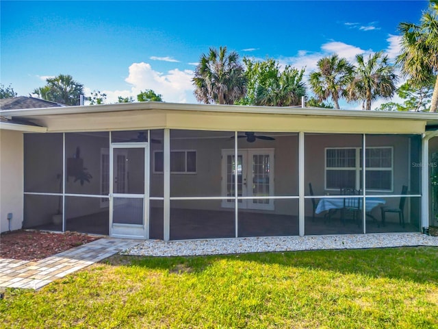 9679 W Pimpernel Ln, Crystal River, FL 34429 - rear view of property with a yard, a sunroom, stucco siding, and french doors