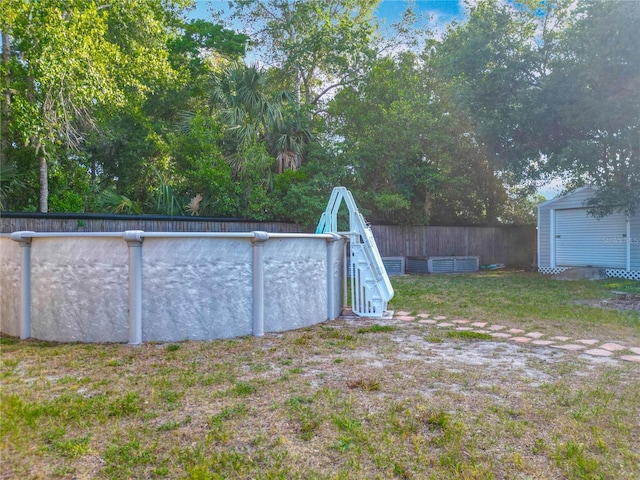 9679 W Pimpernel Ln, Crystal River, FL 34429 - view of yard featuring a storage shed, an outbuilding, fence, and an outdoor pool