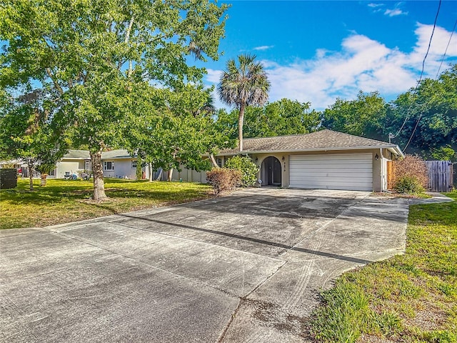 9679 W Pimpernel Ln, Crystal River, FL 34429 - single story home featuring an attached garage, stucco siding, fence, concrete driveway, and a front lawn