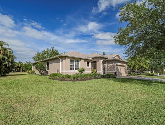 single story home featuring stucco siding, a garage, a front lawn, and driveway