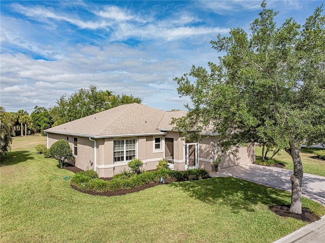 view of front facade with concrete driveway, stucco siding, and a front yard