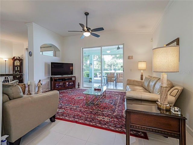 living room with tile patterned flooring, ornamental molding, and a ceiling fan