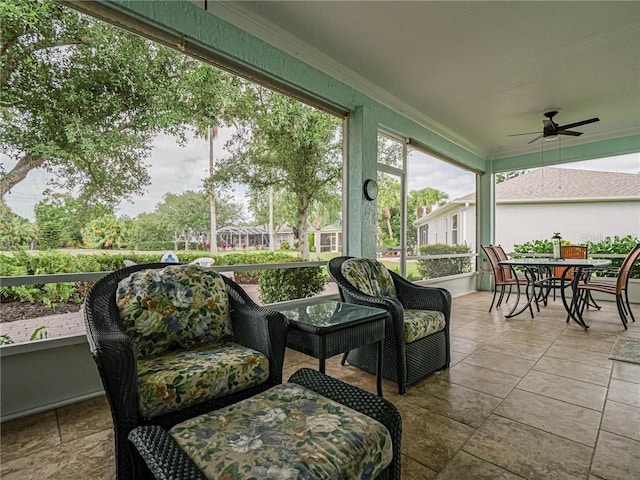 sunroom / solarium with ceiling fan and outdoor dining space