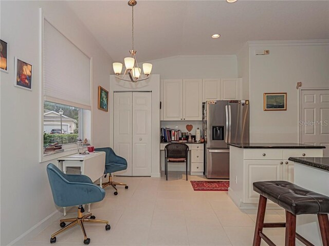 kitchen with dark countertops, a notable chandelier, stainless steel fridge with ice dispenser, white cabinetry, and recessed lighting
