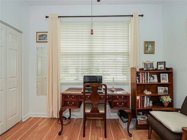 office area featuring baseboards and wood finished floors