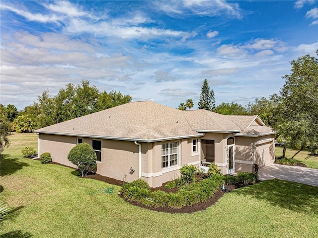 exterior space featuring a front yard, stucco siding, driveway, and a garage