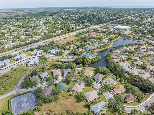 drone / aerial view featuring a water view and a residential view