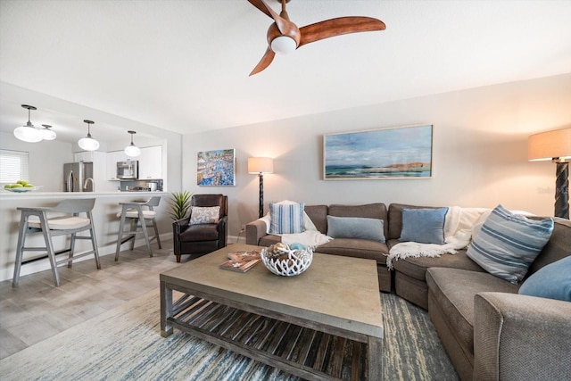 868 Bayway Blvd Unit 206, Clearwater Beach, FL 33767 - living area with a ceiling fan, wood finished floors, and baseboards