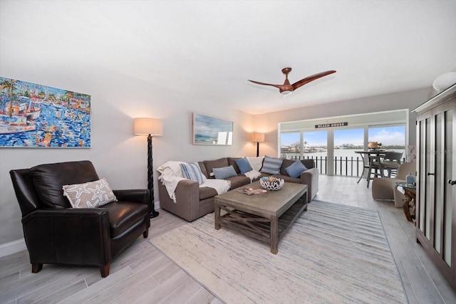 868 Bayway Blvd Unit 206, Clearwater Beach, FL 33767 - living room featuring light wood finished floors, ceiling fan, and a water view