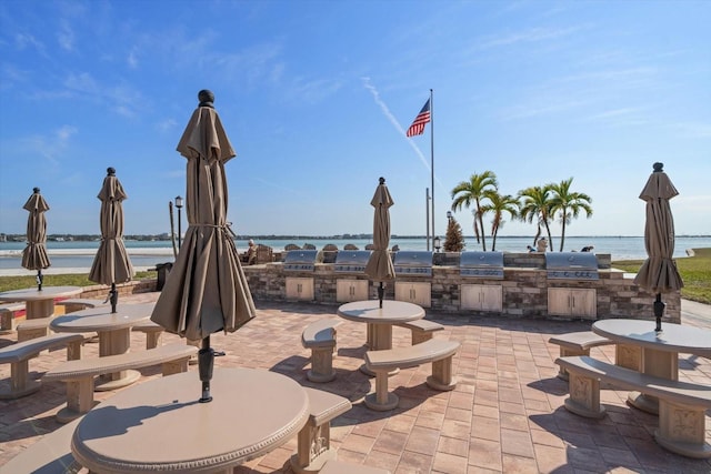 868 Bayway Blvd Unit 206, Clearwater Beach, FL 33767 - view of patio featuring area for grilling and a water view