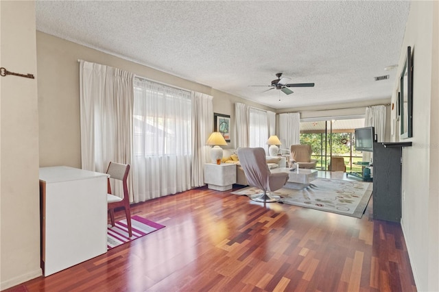 12804 Wedgewood Way Unit C, Hudson, FL 34667 - living area with a textured ceiling, wood finished floors, and ceiling fan