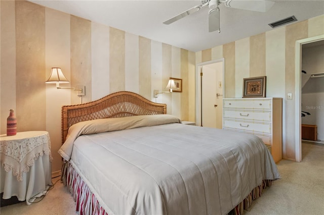 12804 Wedgewood Way Unit C, Hudson, FL 34667 - bedroom with wallpapered walls, light carpet, and ceiling fan