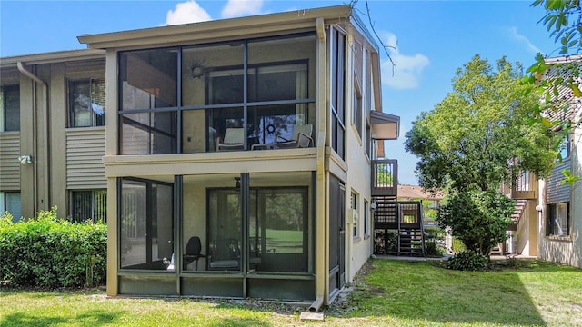 12804 Wedgewood Way Unit C, Hudson, FL 34667 - back of property with a sunroom, stairs, and a lawn