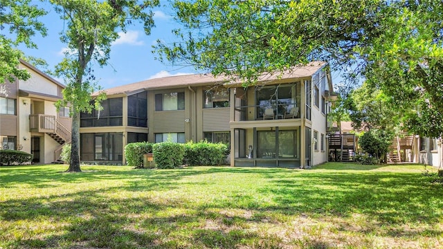 12804 Wedgewood Way Unit C, Hudson, FL 34667 - back of property with a sunroom, stairs, and a yard