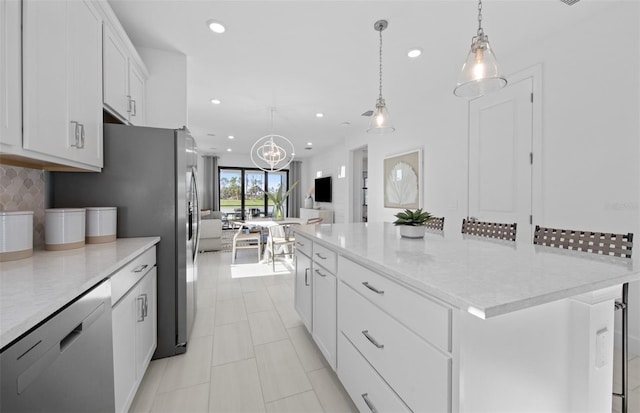 kitchen featuring dishwasher, backsplash, recessed lighting, white cabinetry, and a spacious island