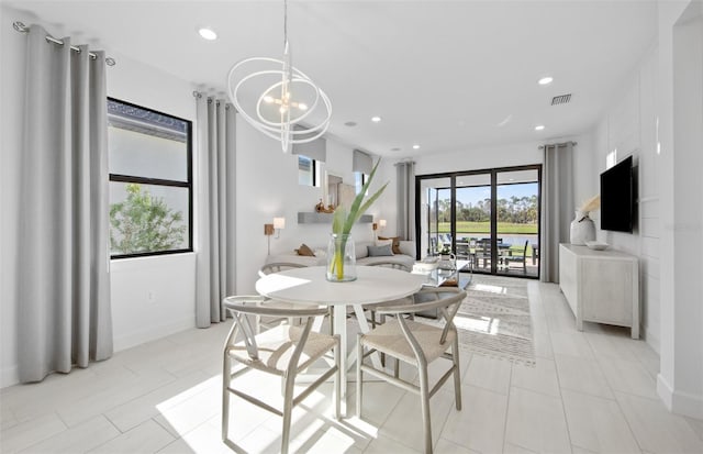 dining space with a chandelier, light tile patterned flooring, recessed lighting, and baseboards