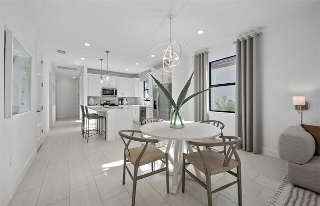 dining area featuring recessed lighting, baseboards, a chandelier, and light tile patterned floors