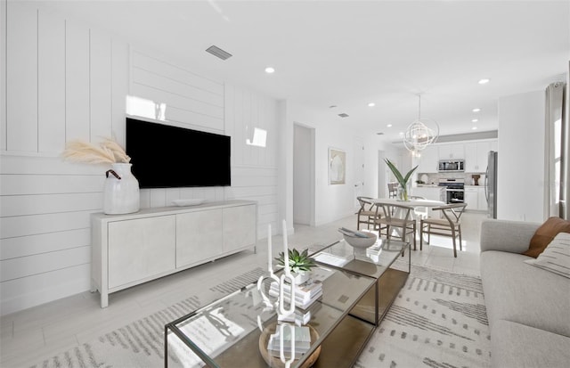 living area featuring recessed lighting, a chandelier, and baseboards