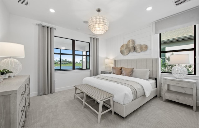 bedroom with light colored carpet, multiple windows, recessed lighting, and baseboards