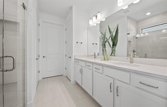 bathroom featuring a stall shower and double vanity