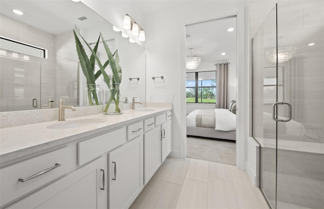 ensuite bathroom with double vanity, a shower stall, recessed lighting, and tile patterned flooring