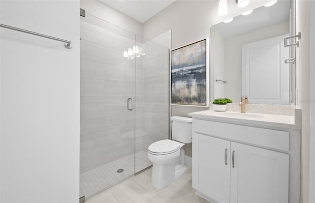 full bathroom featuring toilet, a stall shower, vanity, and tile patterned flooring