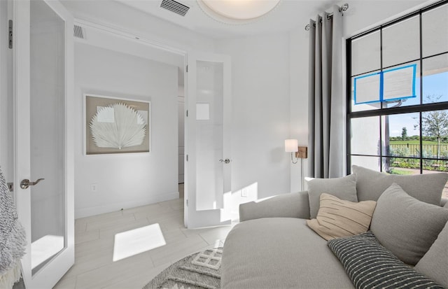 living area featuring tile patterned flooring and baseboards