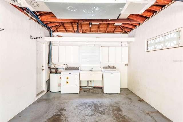 interior space featuring a garage, a sink, laundry area, washing machine and clothes dryer, and electric water heater