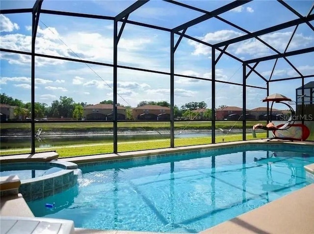 1030 Marcello Blvd, Kissimmee, FL 34746 - view of pool featuring a pool with connected hot tub, a lanai, a water view, and a yard