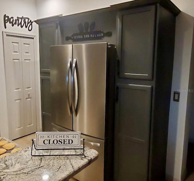 1030 Marcello Blvd, Kissimmee, FL 34746 - kitchen featuring freestanding refrigerator and light stone countertops