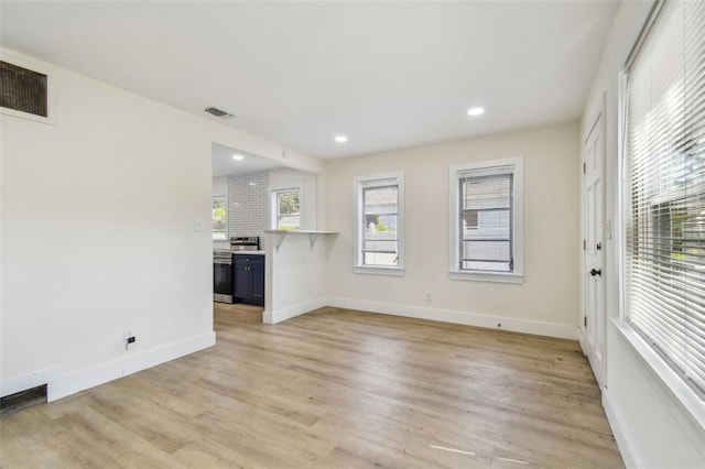 3535 16th St N, Saint Petersburg, FL 33704 - unfurnished living room featuring light wood finished floors, baseboards, and recessed lighting
