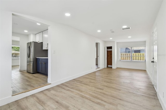 3535 16th St N, Saint Petersburg, FL 33704 - unfurnished living room with light wood-style flooring, recessed lighting, and baseboards