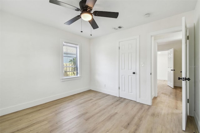 3535 16th St N, Saint Petersburg, FL 33704 - unfurnished bedroom featuring light wood-style flooring, baseboards, ceiling fan, and a closet