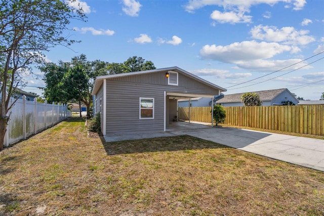 3535 16th St N, Saint Petersburg, FL 33704 - back of property with concrete driveway and a carport