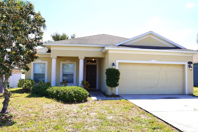 view of front of house with a garage, stucco siding, concrete driveway, a shingled roof, and a front lawn
