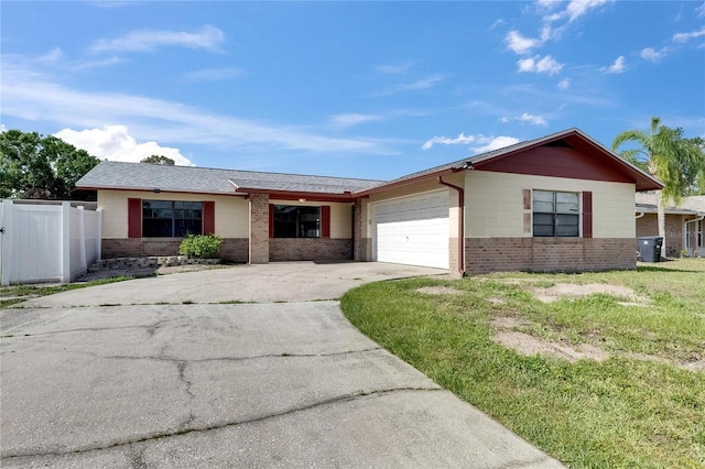 811 Pebblewood Dr, Brandon, FL 33511 - ranch-style house featuring brick siding, fence, an attached garage, and driveway