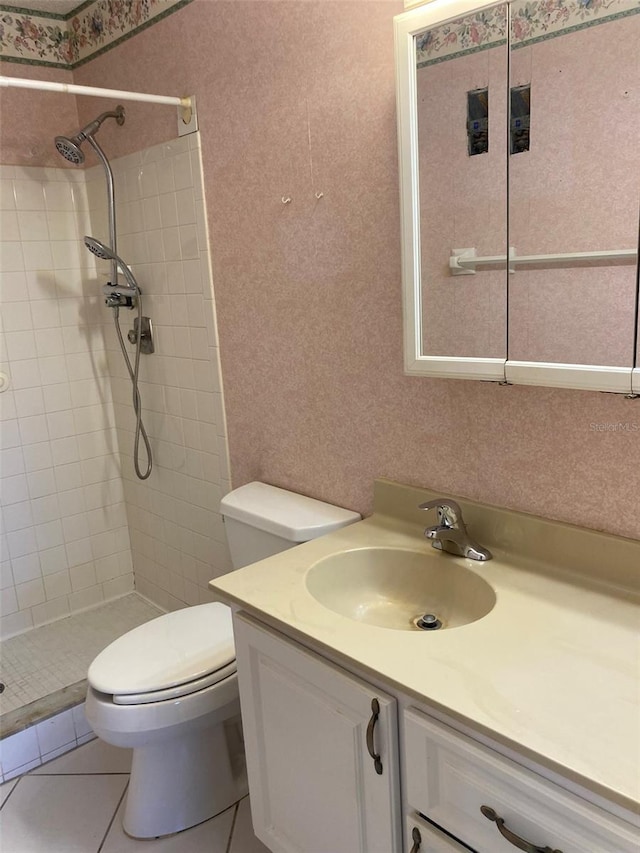 bathroom with toilet, tile patterned floors, vanity, and a shower stall