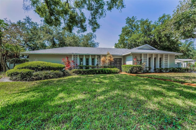 single story home featuring a front lawn and stucco siding