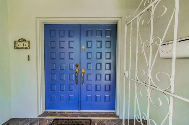 view of exterior entry with a garage
