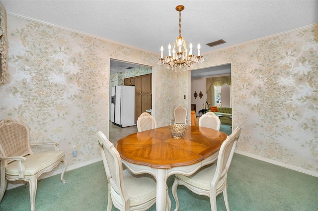 dining area with a chandelier, crown molding, light colored carpet, a textured ceiling, and baseboards