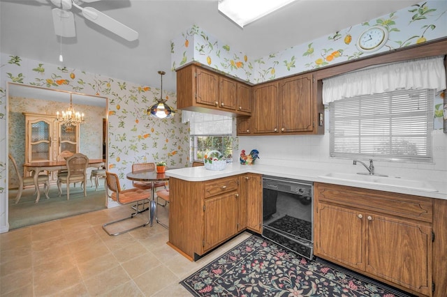 kitchen featuring dishwasher, wallpapered walls, a sink, a ceiling fan, and light countertops