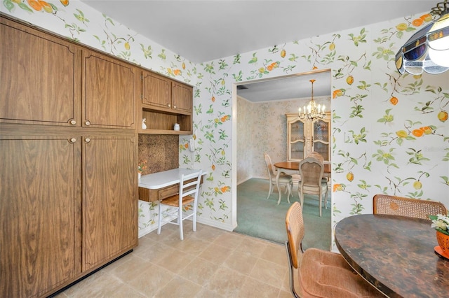 dining room with wallpapered walls, a chandelier, and baseboards