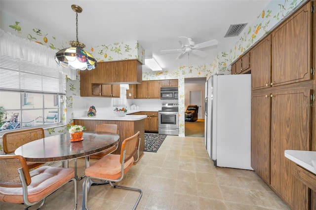 kitchen featuring electric range, white refrigerator with ice dispenser, black microwave, brown cabinetry, and ceiling fan
