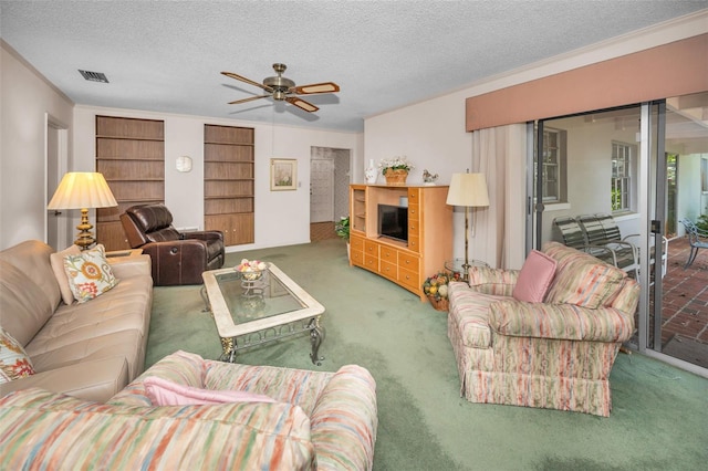living room with carpet floors, a ceiling fan, and a textured ceiling