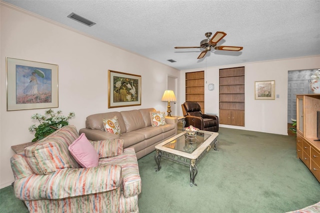 living room with carpet floors, a textured ceiling, a ceiling fan, and built in features
