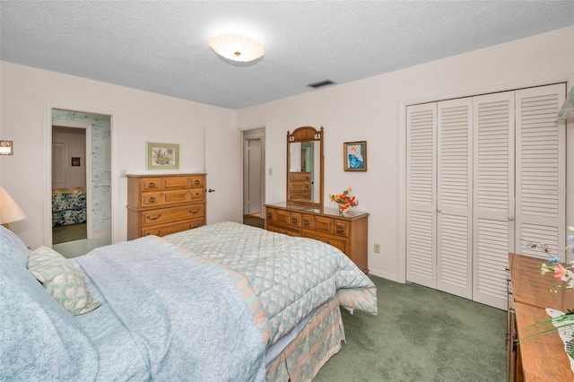 bedroom featuring a closet, dark carpet, and a textured ceiling