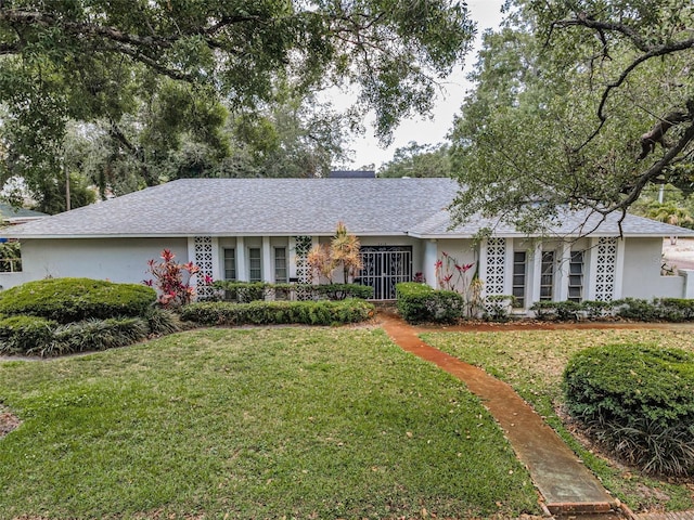 single story home with a front yard and stucco siding