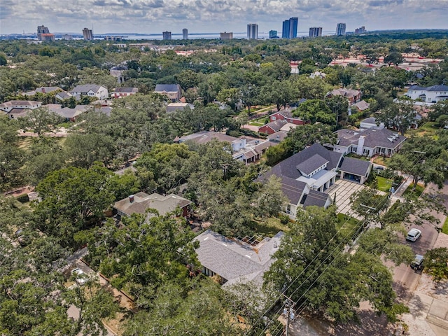 view of urban area with a tree filled landscape