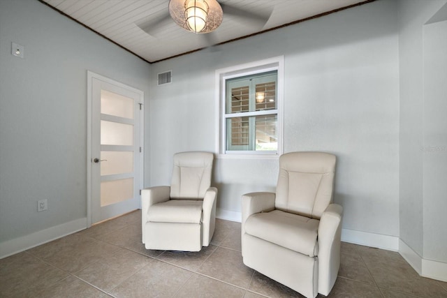 sitting room with baseboards, visible vents, and tile patterned floors