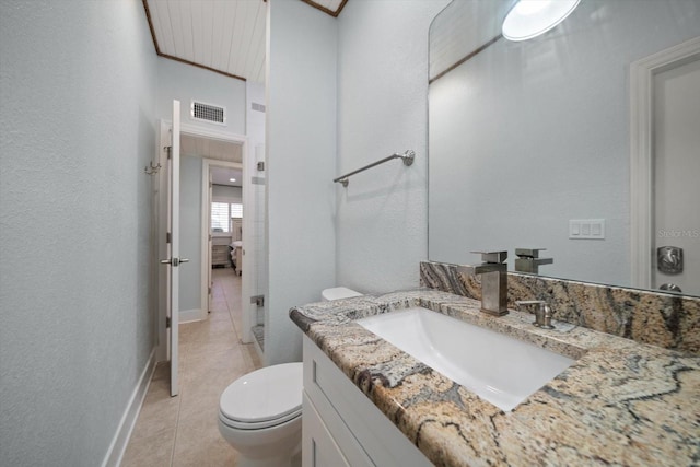 bathroom featuring vanity, toilet, visible vents, and tile patterned floors